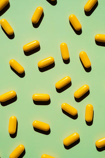 Yellow capsules on a green background