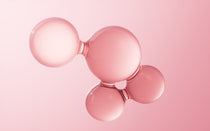 Rose gold ball-shaped object on a pink background