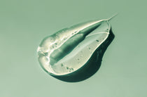 Clear gel smear on a green background