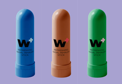 Three nasal inhaler sticks in blue, brown, and green on a purple background