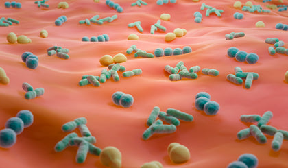 Colorful microscopic view of bacteria on a light pink surface