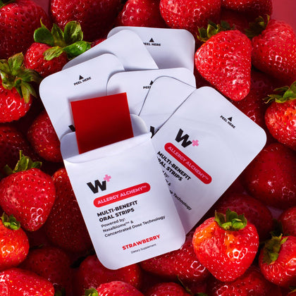 Wizard Wellness multi-benefit oral strips on a bed of strawberries