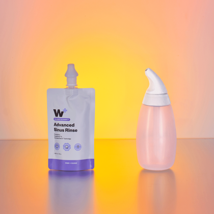 Two bottles of 'Advanced Sinus Rinse' on a gradient background