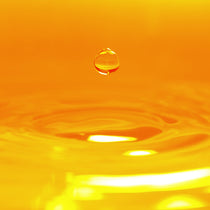 Close-up of a water droplet on an orange background