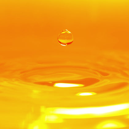 Close-up of a water droplet on an orange background